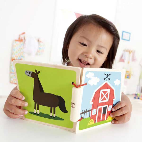 Toddler with Wooden Baby Book